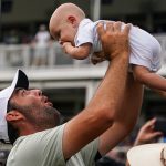 Scottie Scheffler holds son