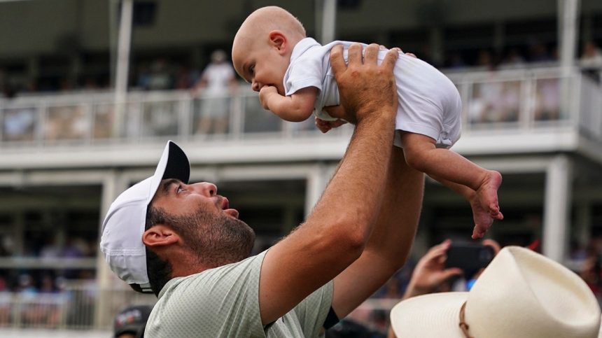 Scottie Scheffler holds son